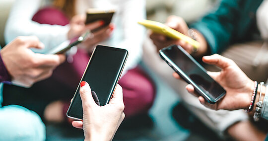 Nahaufnahme von Händen und Smartphones